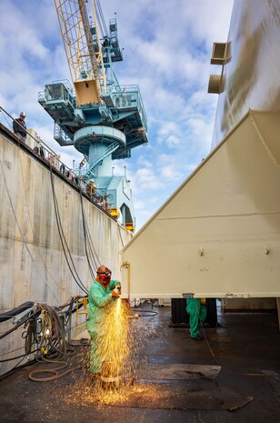 Gilbert Lizama, welder, Shop 26, Welders, works on a Reactor Compartment Disposal package in Dry Dock 3 Sept. 12, 2024, while preparing it for shipping at Puget Sound Naval Shipyard & Intermediate Maintenance Facility in Bremerton, Washington. (U.S. Navy photo by Wendy Hallmark)