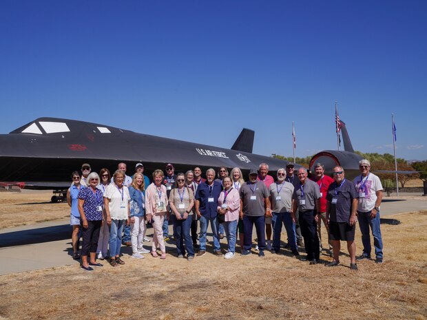 Members of the Wheatland Union High School Class of 1974 pose for a group photo near an SR-71 Blackbird static display at Beale Air Force Base, California, Sept. 20, 2024.