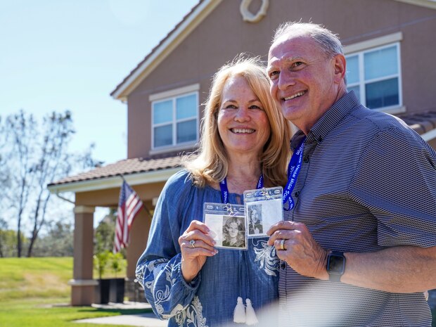 Peggy O'Malley, and Richard Neal, Wheatland Union High School (WUHS) alumni, pose with their yearbook photos from 1974 on Lakeview Drive at Beale Air Force Base, California, Sept. 20, 2024.