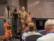 U.S. Air Force Senior Airman Adam Dzekunskas, 9th Physiological Support Squadron technician, demonstrates a high-pressure suit to Wheatland Union High School alumni at Beale Air Force Base, California, Sept. 20, 2024.