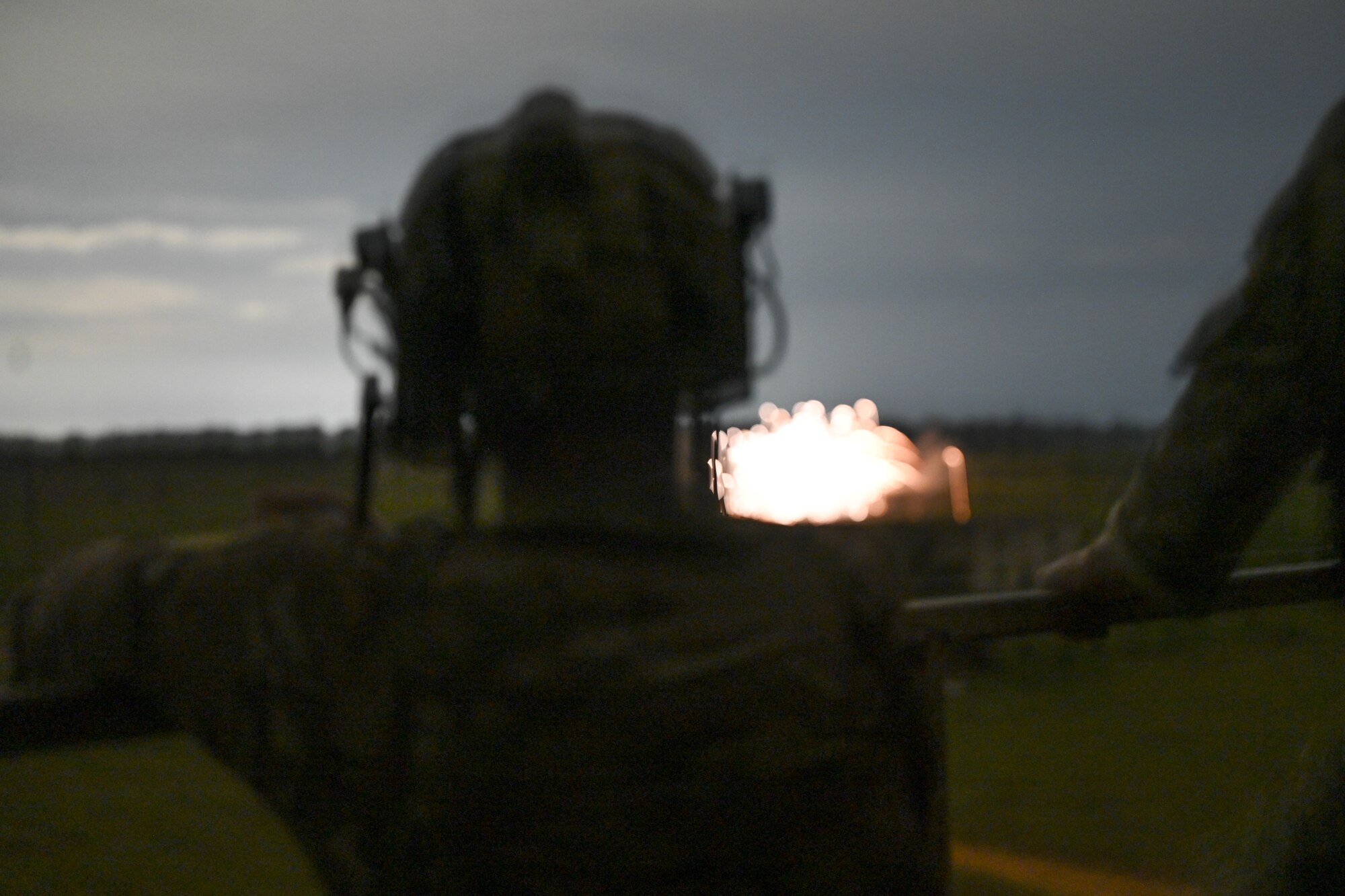 A member of the U.K. military watches as an AC-130J Ghostrider gunship fires on a target during Exercise Emerald Warrior Spiral at the Eglin Range near Hurlburt Field, Florida, Sept. 3, 2024.
