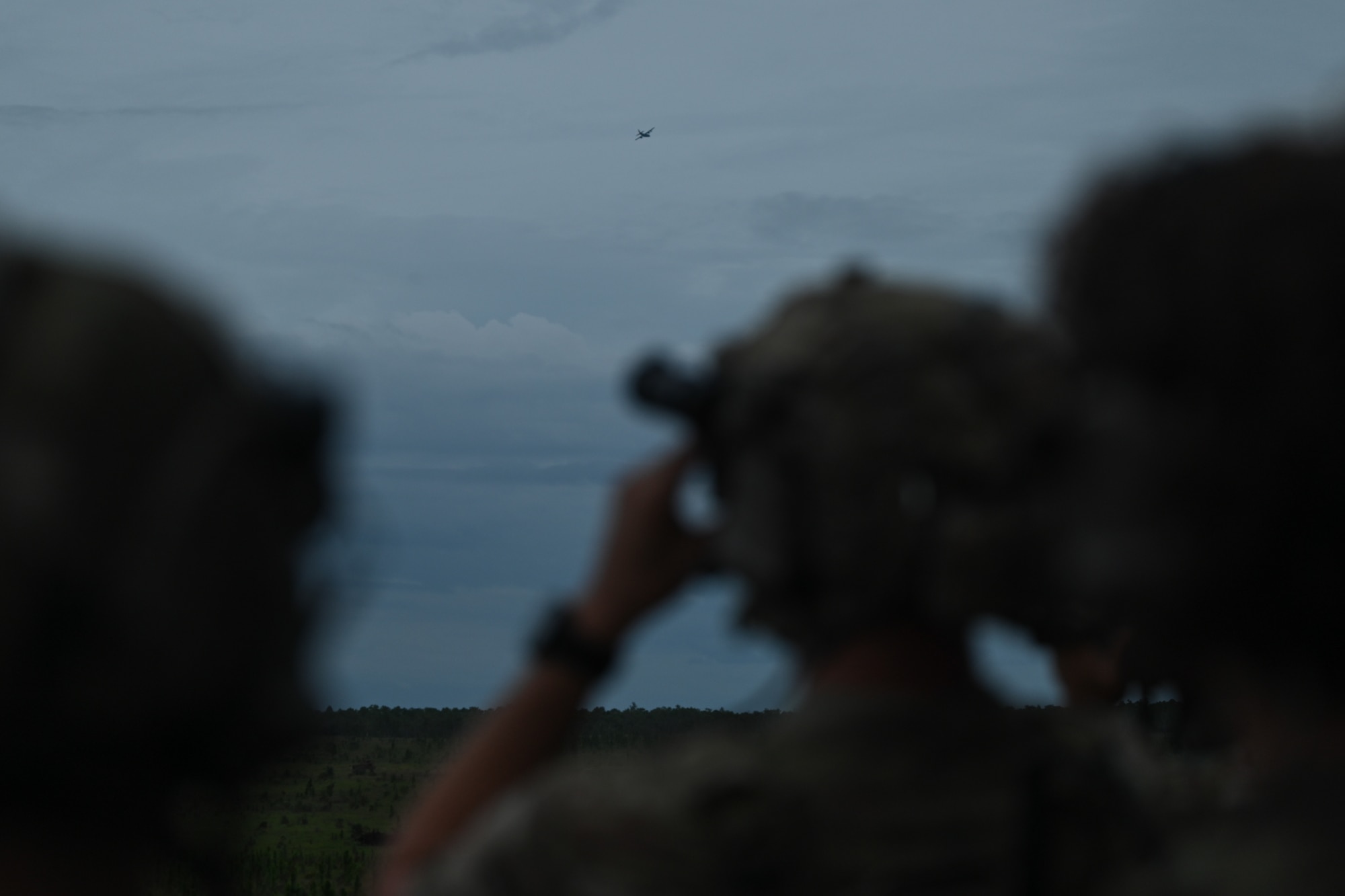 Members of the U.K. military watch an AC-130J Ghostrider gunship as it prepares for live-fire training during Exercise Emerald Warrior Spiral at the Eglin Range near Hurlburt Field, Florida, Sept. 3, 2024.