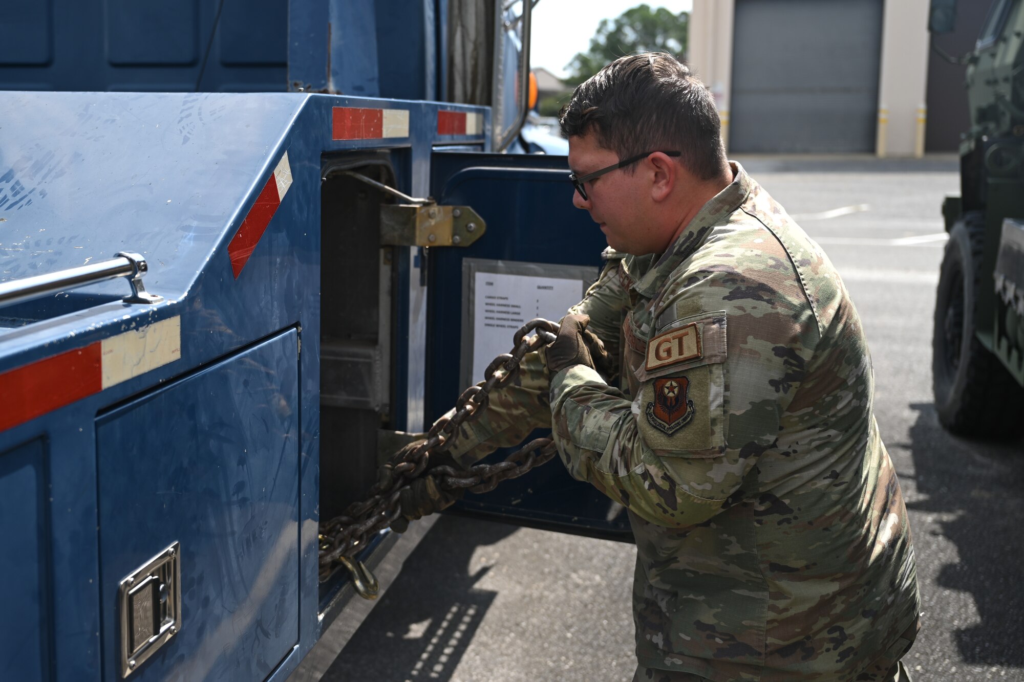 U.S. Air Force Senior Airman Christian Biesecker, a 1st Special Operations Wing ground transportation operator, grabs a chain from a wrecker tow truck at Hurlburt Field, Florida, Sept. 18, 2024.