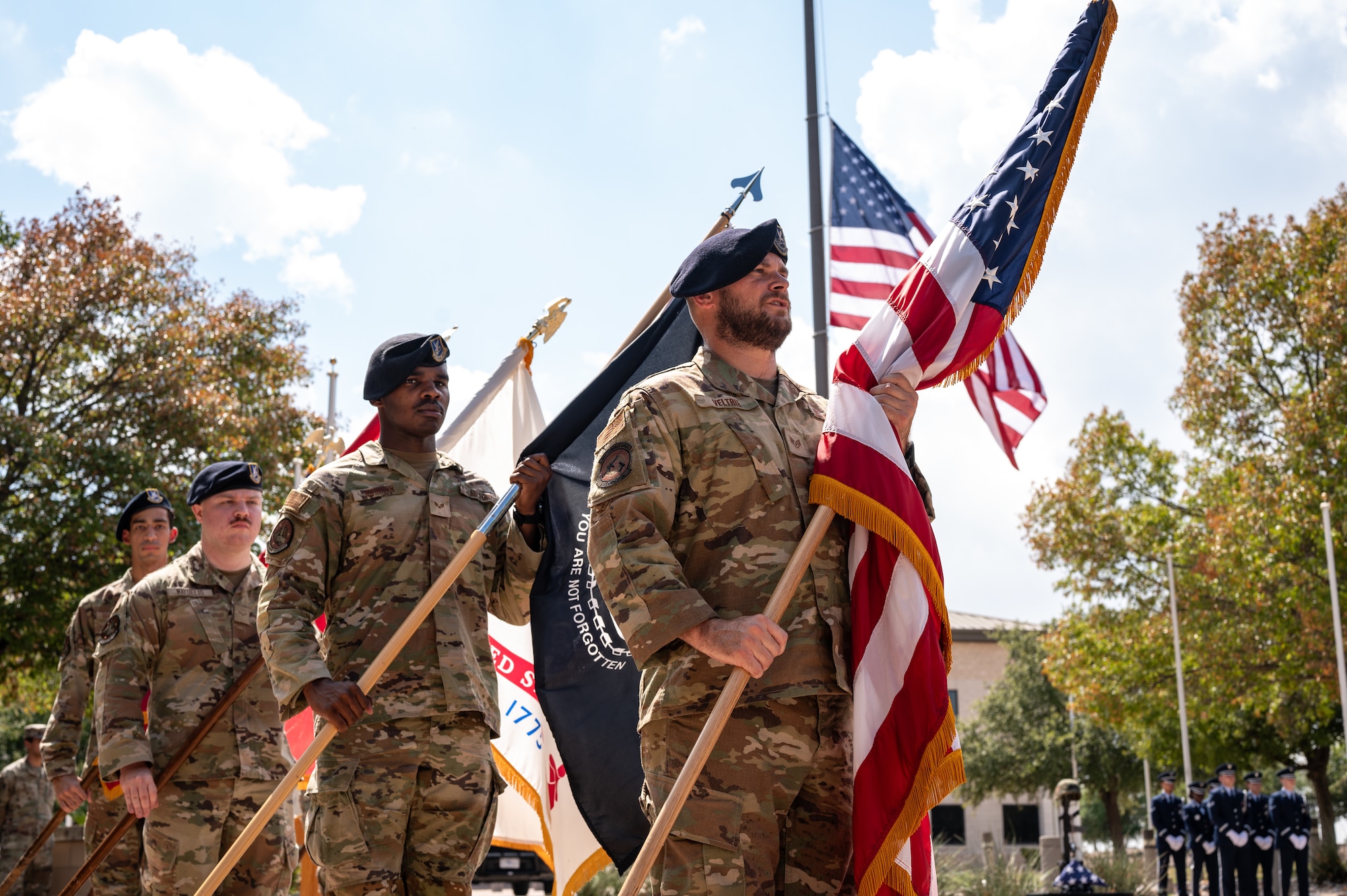 U.S. Air Force Airmen from the 47th Security Forces Squadron hold flags during a Prisoners of War (POW) and Missing in Action (MIA) closing ceremony at Laughlin Air Force Base, Texas, Sept. 20, 2024. The POW/MIA flag was created by the National League of Families in 1971. (U.S. Air Force photo by Senior Airman Keira Rossman)