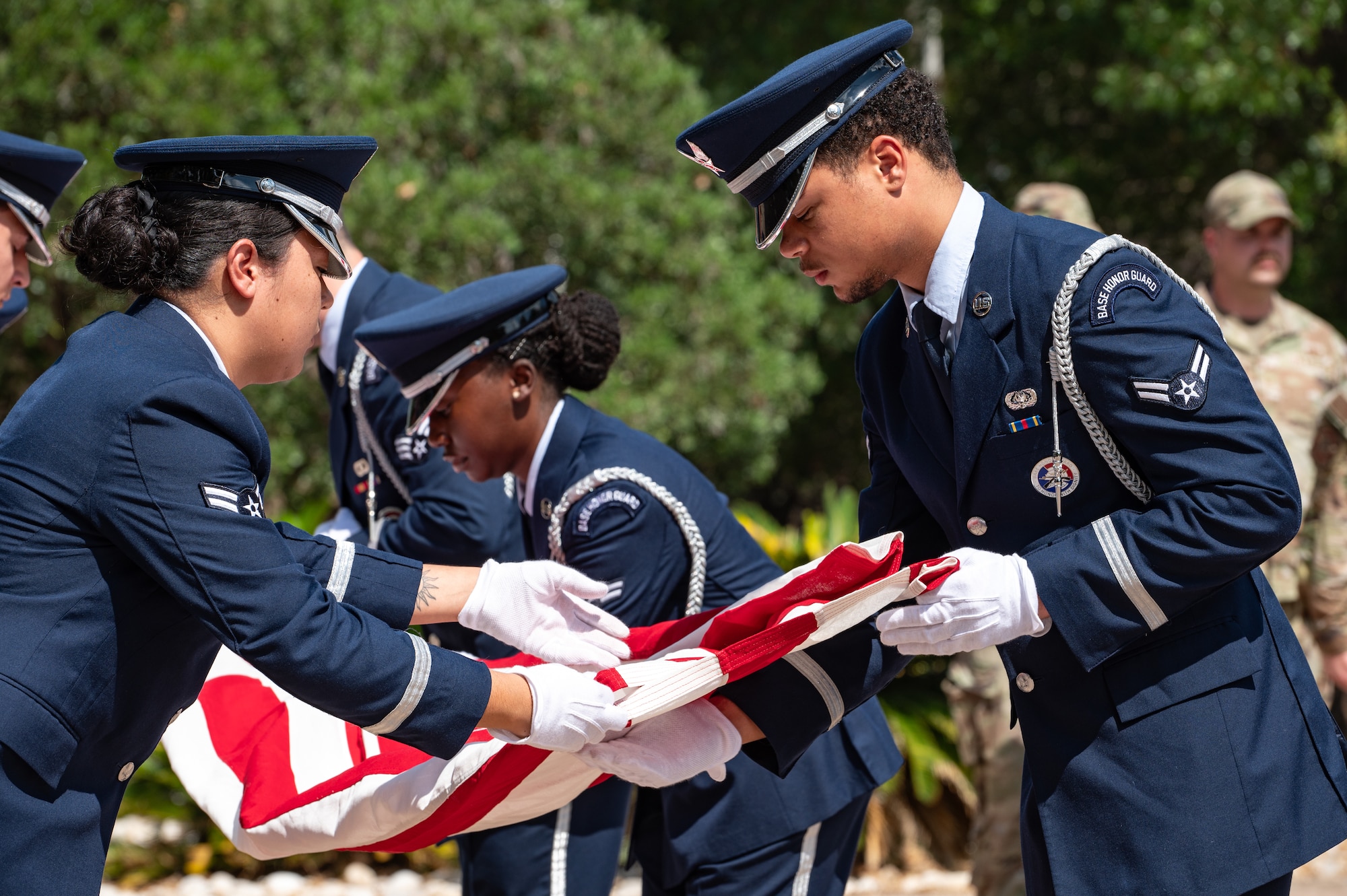 U.S. Air Force Airmen from the base Honor Guard team fold an American flag during a Prisoners of War (POW) and Missing in Action (MIA) closing ceremony at Laughlin Air Force Base, Texas, Sept.  20, 2024. The POW/MIA Recognition Day is nationally recognized on the third Friday in September each year. (U.S. Air Force photo by Senior Airman Keira Rossman)
