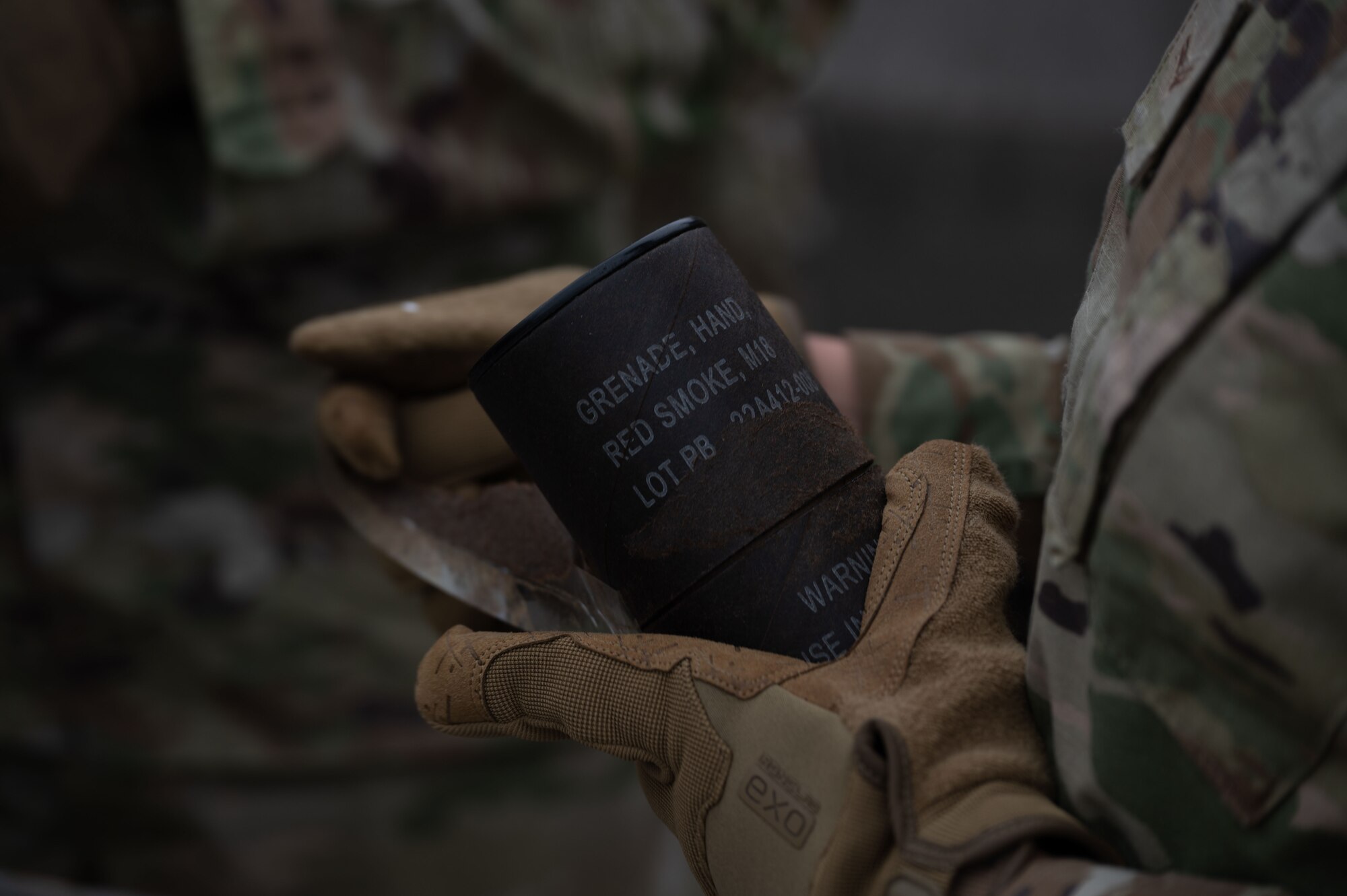 U.S. Air Force Airman 1st Class Kayla Delvalle, 436th Security Forces Squadron response force member, takes a smoke grenade out of its wrapping during training at Dover Air Force Base, Delaware, Sept. 23, 2024. This training was used to recertify the 436th SFS members on smoke grenade usage. (U.S. Air Force Photo by Senior Airman Dieondiere Jefferies)