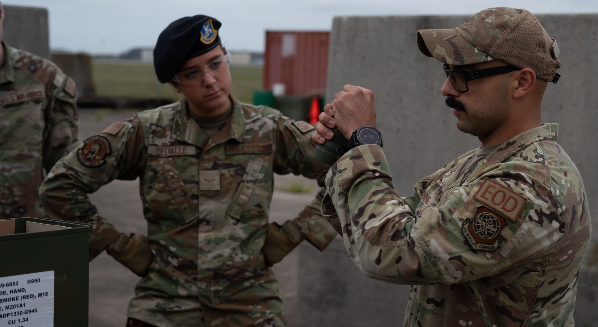 U.S. Air Force Senior Airman Kevin Sinning, 436th Civil Engineer Squadron explosive ordinance disposal apprentice, teaches 436th Security Forces Squadron members the proper way to hold a smoke grenade during training at Dover Air Force Base, Delaware, Sept. 23, 2024. This training was used to recertify the 436th SFS members on smoke grenade usage. (U.S. Air Force Photo by Senior Airman Dieondiere Jefferies)