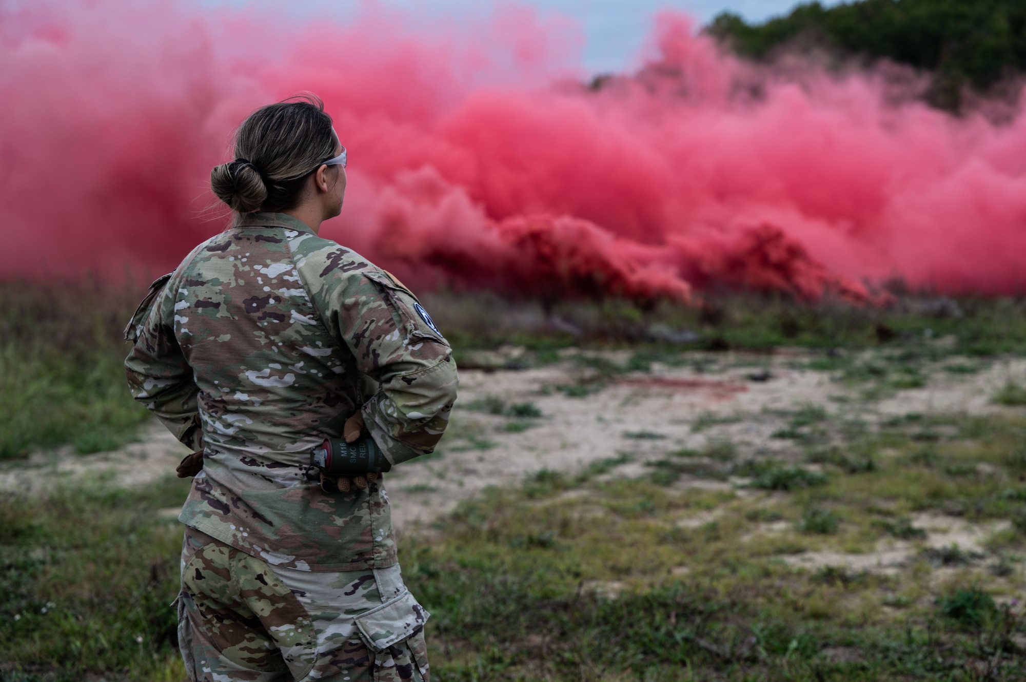 U.S. Air Force Staff Sgt. Megan Quaine, 436th Security Forces Squadron standardization and evaluations evaluator, waits to throw a smoke grenade during training at Dover Air Force Base, Delaware, Sept. 23, 2024. This training was used to recertify the 436th SFS members on smoke grenade usage. (U.S. Air Force Photo by Senior Airman Dieondiere Jefferies)