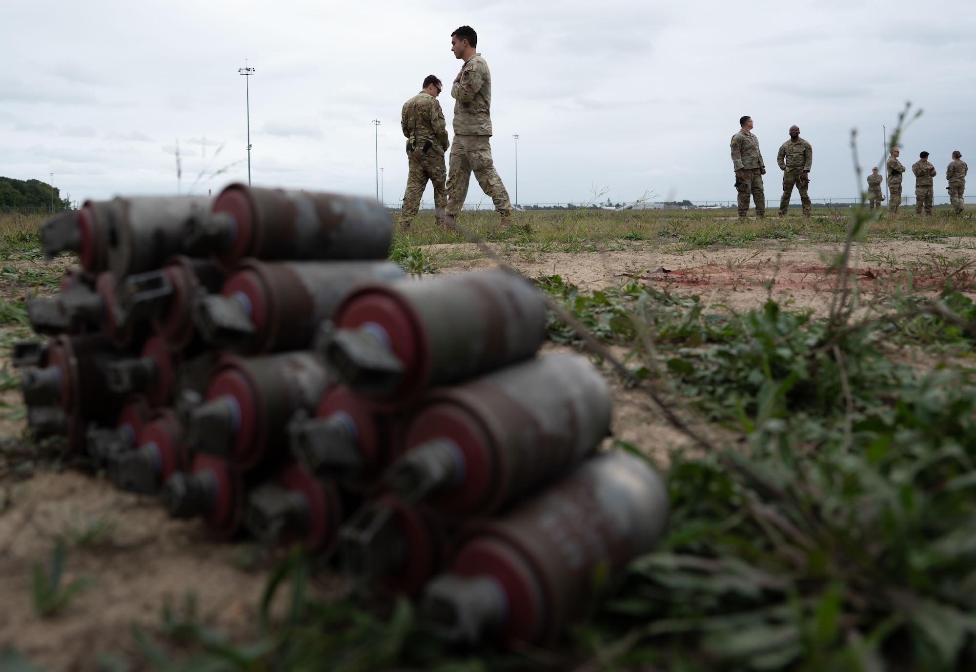 436th Security Forces Squadron members clean up empty smoke grenade canisters during training at Dover Air Force Base, Delaware, Sept. 23, 2024. This training was used to recertify the 436th SFS members on smoke grenade usage. (U.S. Air Force Photo by Senior Airman Dieondiere Jefferies)