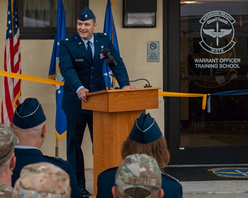 U.S. Air Force Maj. Nathaniel Roesler, Warrant Officer Training School commandant, gives remarks at the WOTS ribbon cutting ceremony at Maxwell Air Force Base, Alabama, Sept. 25, 2024. The reintroduction of the Warrant Officer Corps career path intends to address critical operational needs, while maintaining highly perishable skills, and simultaneously leveraging the unique expertise and capabilities of warrant officers. (U.S. Air Force photo by Senior Airman Evan Lichtenhan)