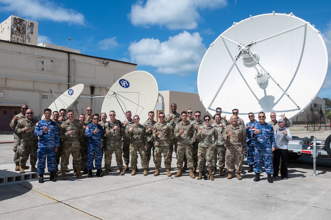 Participants of the Vulcan Guard Bolt-7 Space subject matter expert exchange receive a tour of the 109th Electromagnetic Warfare Squadron Sept. 16, 2024, at Joint Base Pearl Harbor-Hickam, Hawaii. The Hawaii Air National Guard hosted this multinational event to foster collaboration and enhance space capabilities.