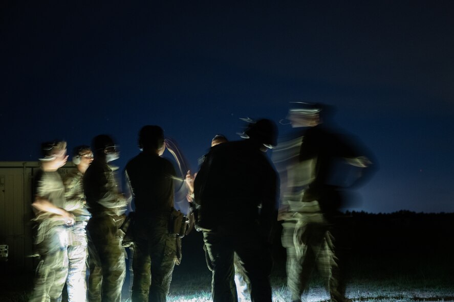 U.S. Airmen assigned to the 1st Special Operations Support Squadron Mission Sustainment Team discuss details of a night range exercise at Eglin Air Force Base, Florida, Aug. 27, 2024.