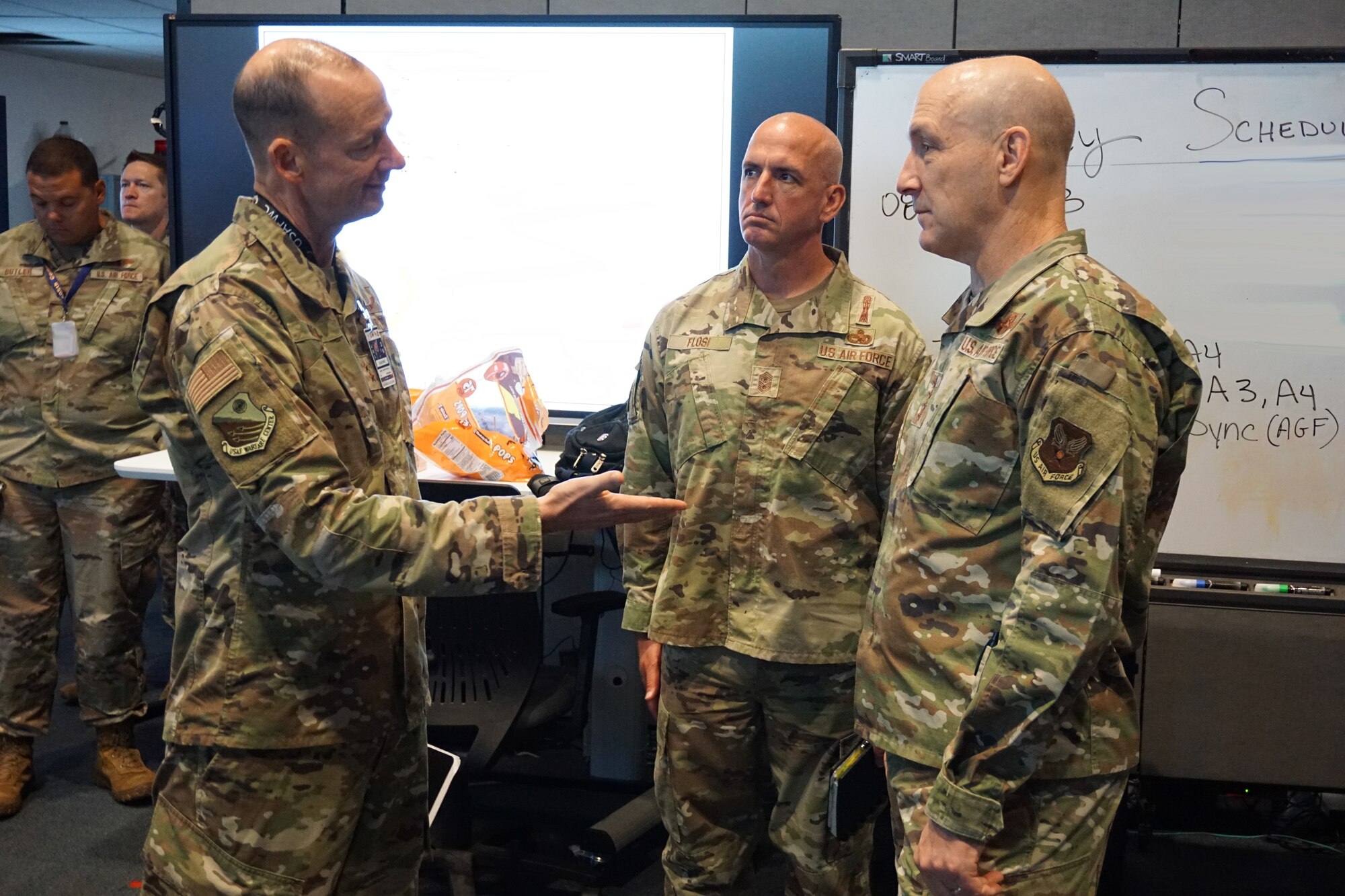 uniformed Chief of Staff of the Air Force Gen. David Allvin and Chief Master Sgt. of the Air Force Chief David Flosi listen to Maj. Gen. Christopher Niemi discuss Bamboo Eagle 24-3's operational-level of war elements.