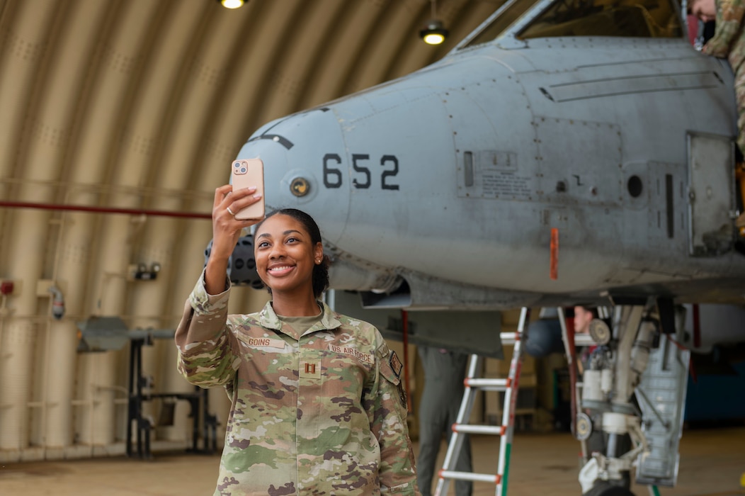 U.S. Air Force Capt. Kierra Goins, 51st Medical Group optometrist, takes a photo with an A-10 Thunderbolt II during Integrated Mustang 24-5 at Osan Air Base, Republic of Korea, Sept. 20, 2024. Personnel are briefed on the mission of the A-10 Thunderbolt II, the F-16 Fighting Falcon and the U-2 Dragon Lady before getting to tour the aircraft in person. (U.S. Air Force photo by Senior Airman Kaitlin Frazier)