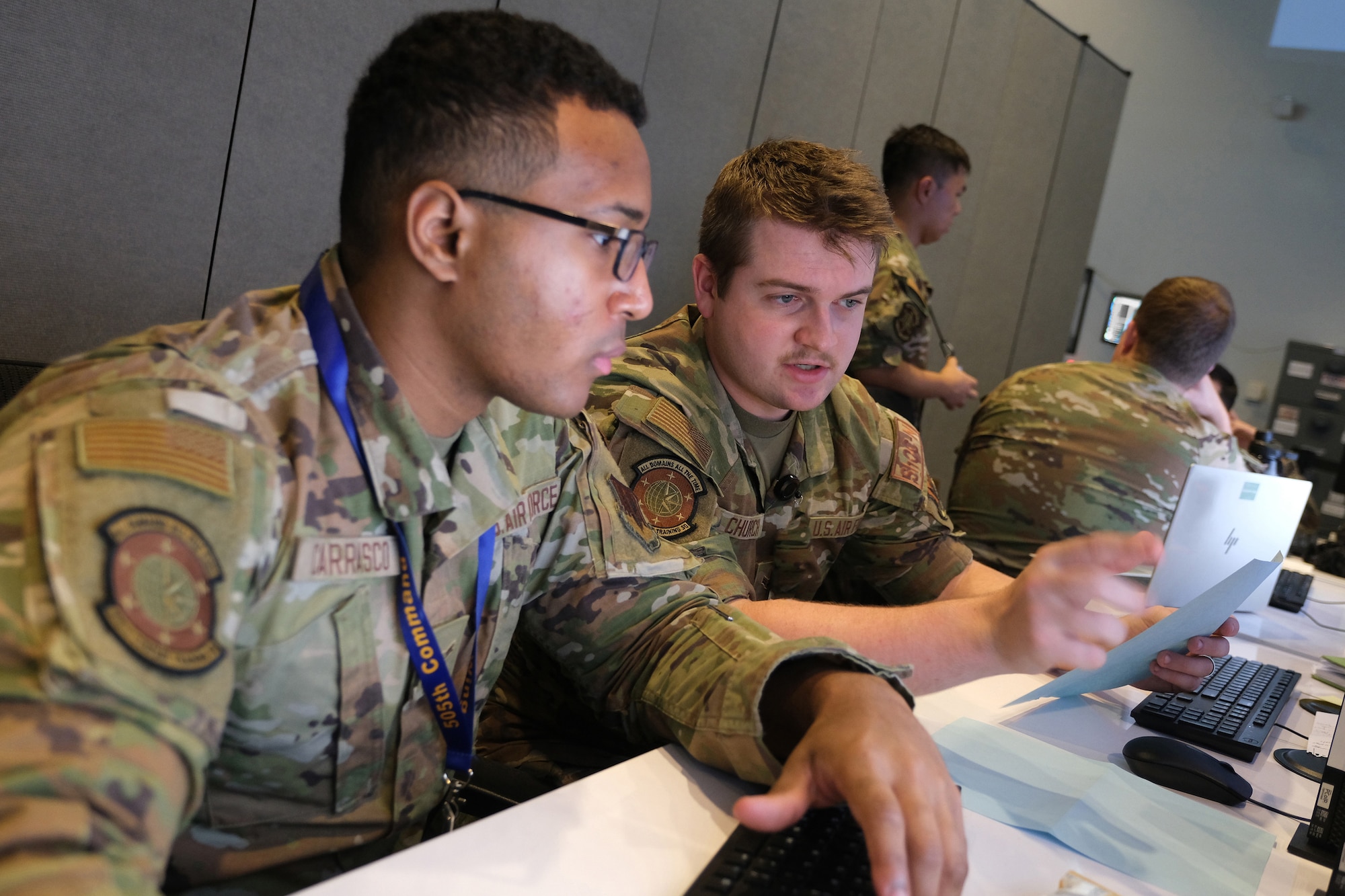 US Air Force Airmen work on computers