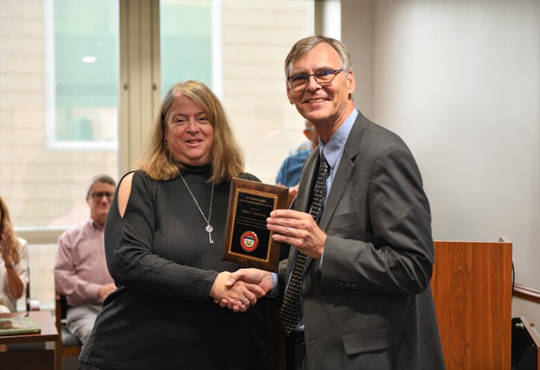 Photo of Real Estate Division Chief Ralph Werthmann and Paula Johnson-Muic, USACE Director of Real Estate holding up the Woodrow Berge Distinguished Award.