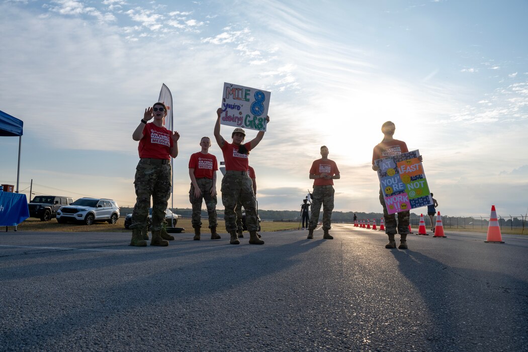 Volunteers hold up signs during the USAF marathon