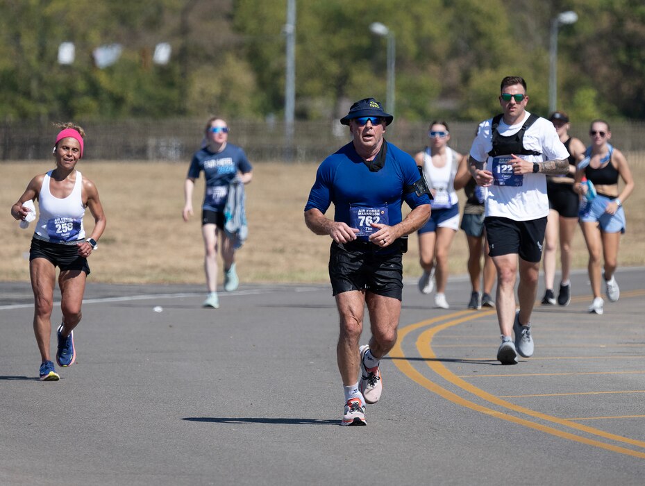 A group of people run towards the camera.