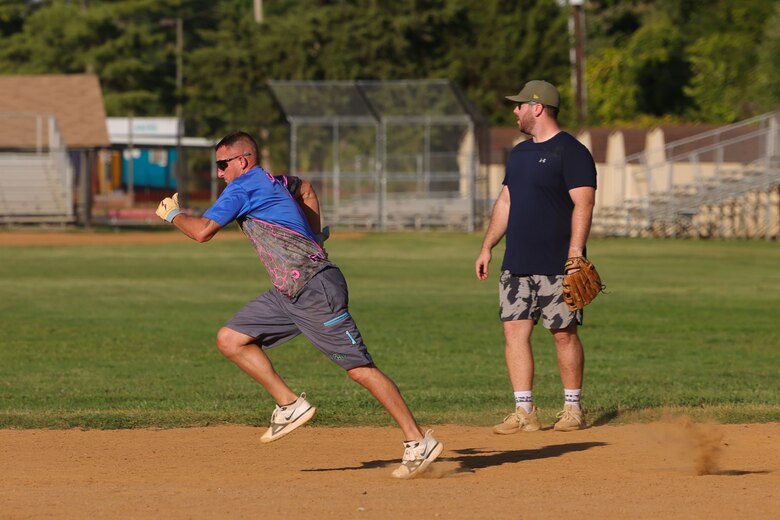 MSgt. Giroir plays softball, pitches, catches, and hits