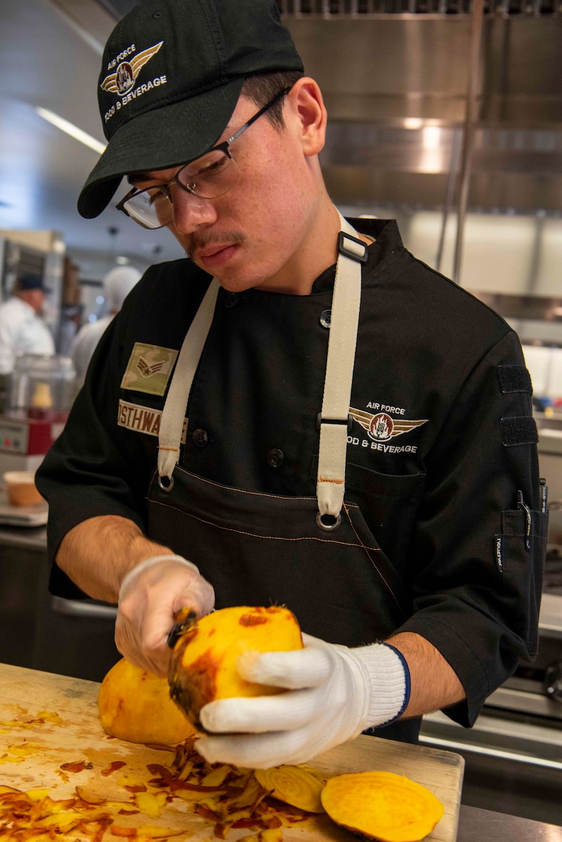 closeup of Airman peeling beet