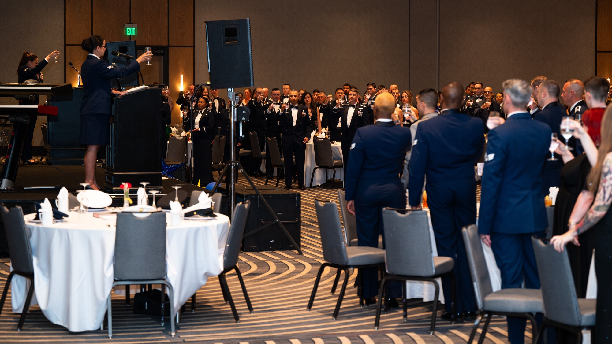Dyess Air Force Ball attendees toast in honor of prisoners of war and those missing in action at the DoubleTree by Hilton, Abilene, Texas, Sept. 21, 2024. It is an Air Force tradition to have a POW/MIA table set up at Air Force Ball events in remembrance of those lost in previous wars. (U.S. Air Force photo by Airman 1st Class Jade M. Caldwell)