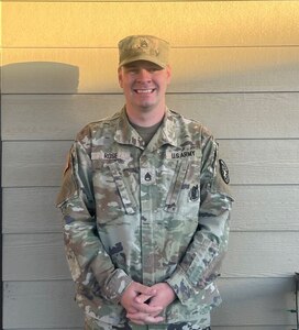 Male U.S. Army Soldier in uniform poses for a headshot.