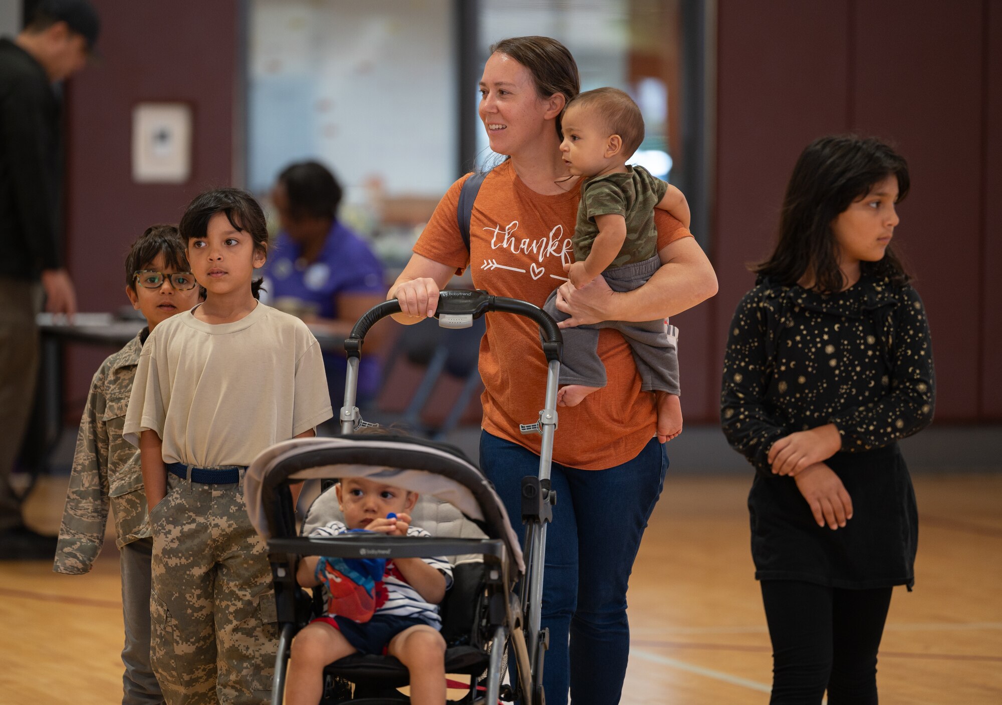 A mother with her children arrived at the R. P. Lee Youth Center where the Operation K.U.D.O.S. event was held.