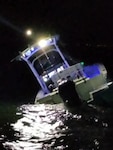 A Coast Guard Station Charleston boat crew rescues two people after their vessel allided with the jetties at the entrance to the Charleston Harbor in Charleston, South Carolina, Sept. 25, 2024.