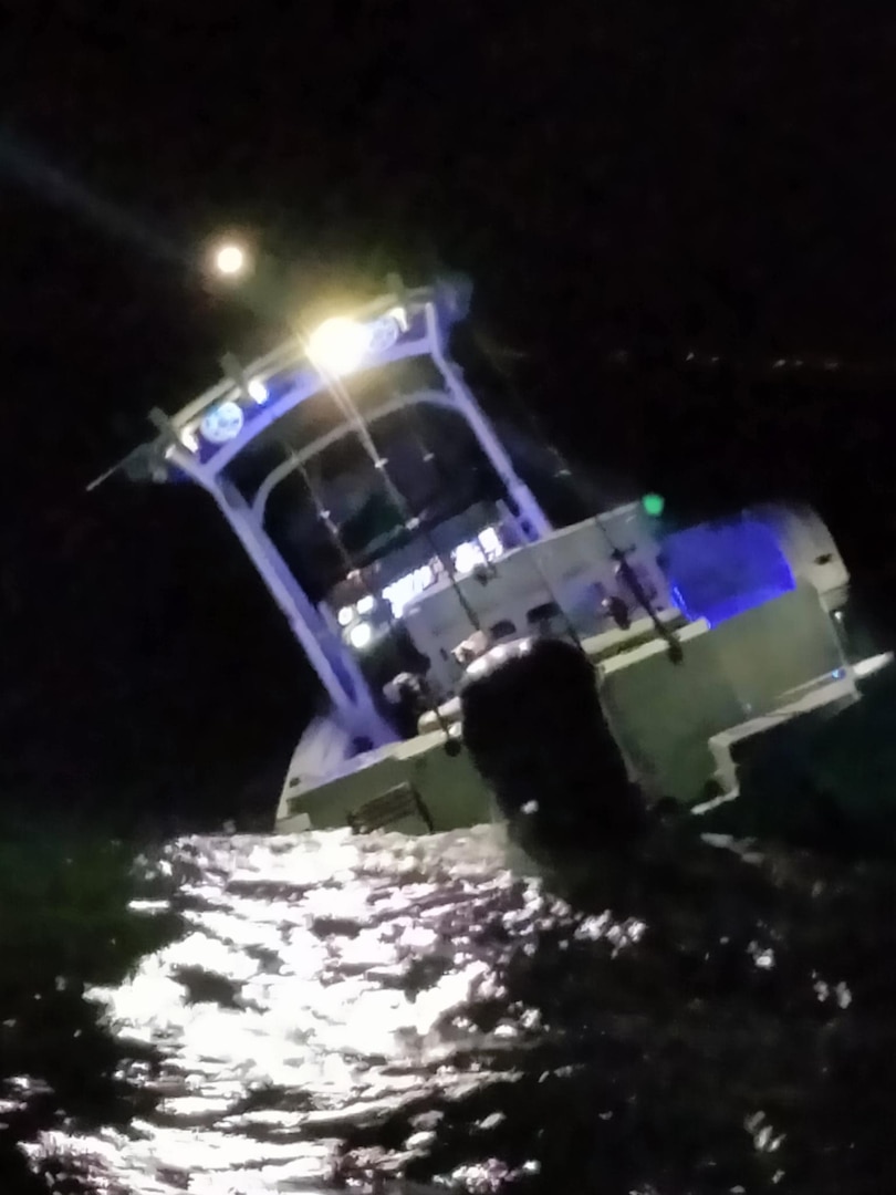 A Coast Guard Station Charleston boat crew rescues two people after their vessel allided with the jetties at the entrance to the Charleston Harbor in Charleston, South Carolina, Sept. 25, 2024.