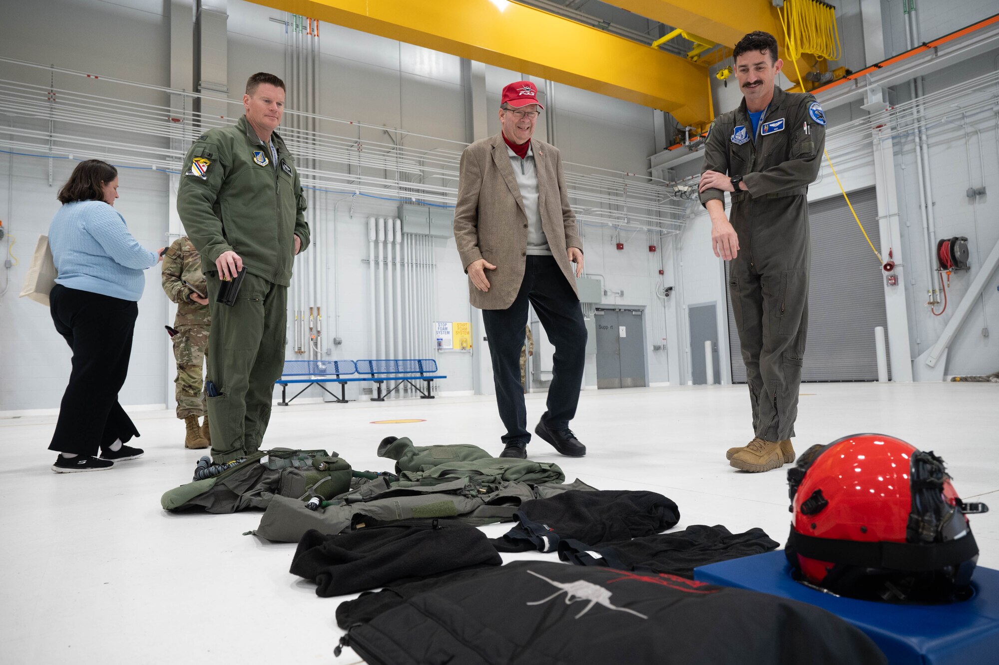 U.S. Air Force Capt. Russell Berringer, 355th Fighter Squadron pilot, right, briefs U.S. Ambassador to Canada David L. Cohen and Col. Paul Townsend, 354th Fighter Wing commander, on the F-35A Lightning II flying kit at Eielson Air Force Base, Alaska, Sept. 13, 2024.