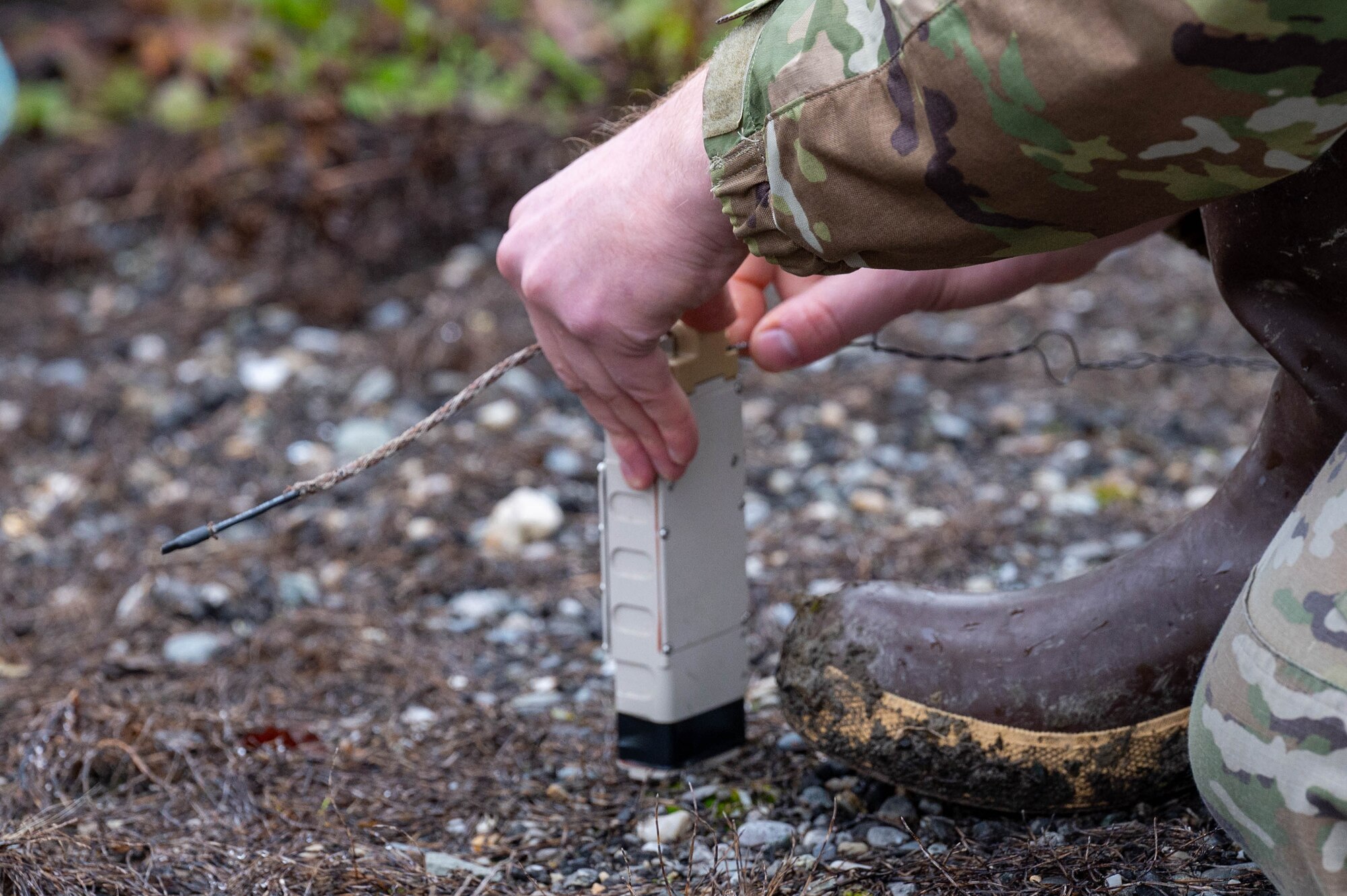 A U.S. Air Force Airman, assigned to the 354th Civil Engineering Squadron explosive ordnance disposal flight, attaches a wire to a blasting cap at Eielson Air Force Base, Alaska, Sept. 20, 2024.