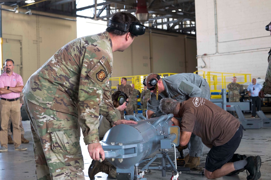 U.S. Airmen, assigned to the 307th Maintenance Squadron, and a U.S. Air Force civilian employees assemble a B-52 Stratofortress towbar prototype during a demonstration of its capabilities at Barksdale Air Force Base, Louisiana, Sept. 10, 2024. The new prototype was created in response to a request for a towbar that can meet the speed and readiness requirements inherent in Agile Combat Employment efforts. (U.S. Air Force photo by Senior Master Sgt. Ted Daigle)