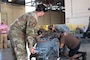 U.S. Airmen, assigned to the 307th Maintenance Squadron, and a U.S. Air Force civilian employees assemble a B-52 Stratofortress towbar prototype during a demonstration of its capabilities at Barksdale Air Force Base, Louisiana, Sept. 10, 2024. The new prototype was created in response to a request for a towbar that can meet the speed and readiness requirements inherent in Agile Combat Employment efforts. (U.S. Air Force photo by Senior Master Sgt. Ted Daigle)