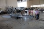 U.S. Airmen, Air Force Global Strike Command officials, and visitors from Louisiana Tech University gather around a new B-52 Stratofortress towbar prototype prior to a demonstration of its capabilities at Barksdale Air Force Base, Louisiana, Sept. 10, 2024. The prototype, an AFGSC initiative, was designed in a collaboration between Louisiana Tech engineering students, and AFGSC’s innovation arm called STRIKEWERX. (U.S. Air Force photo by Senior Master Sgt. Ted Daigle)