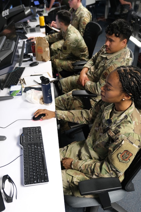 photo of uniformed military members working at computers