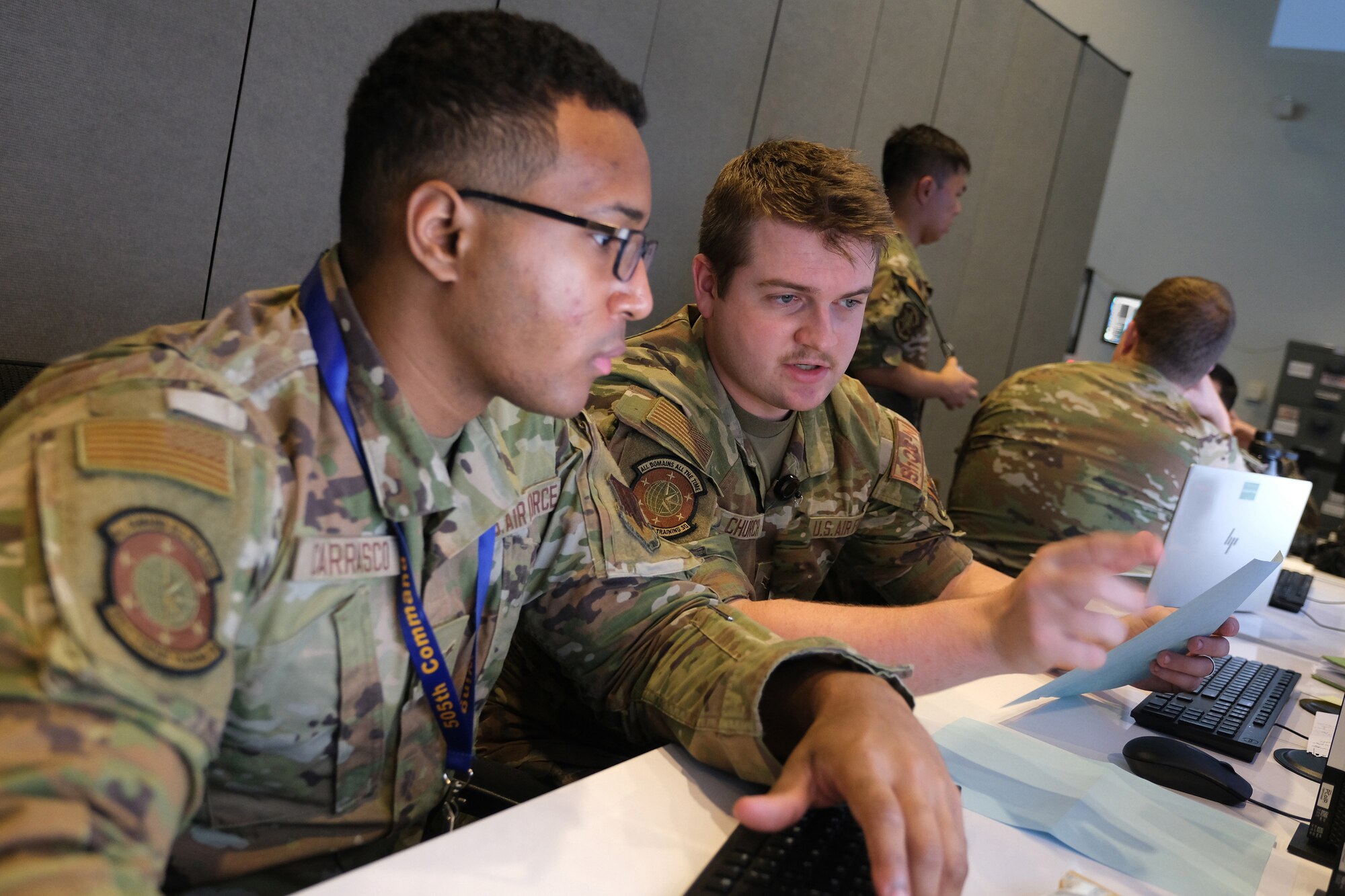 US Air Force Airmen work on computers
