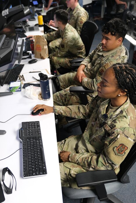photo of uniformed military members working at computers