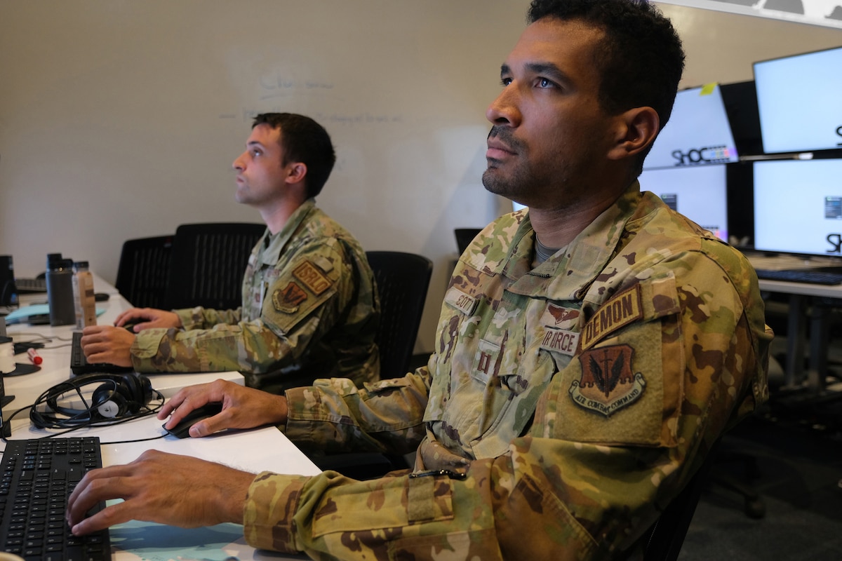 US military members work on computers