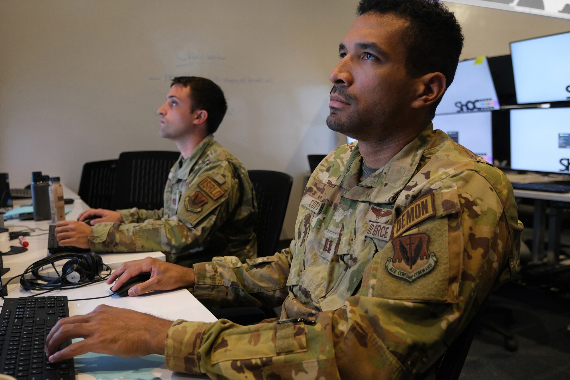 US military members work on computers