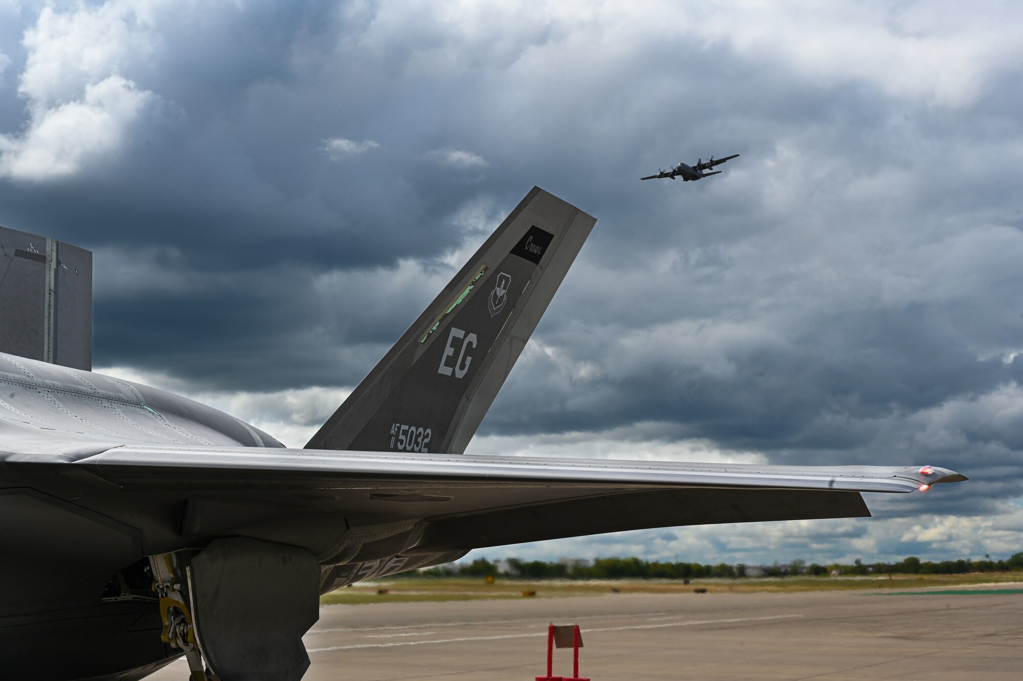 A C-130 Hercules flies over an F-35A Lightning II at Ebbing Air National Guard Base, Arkansas, Sept. 16, 2024.