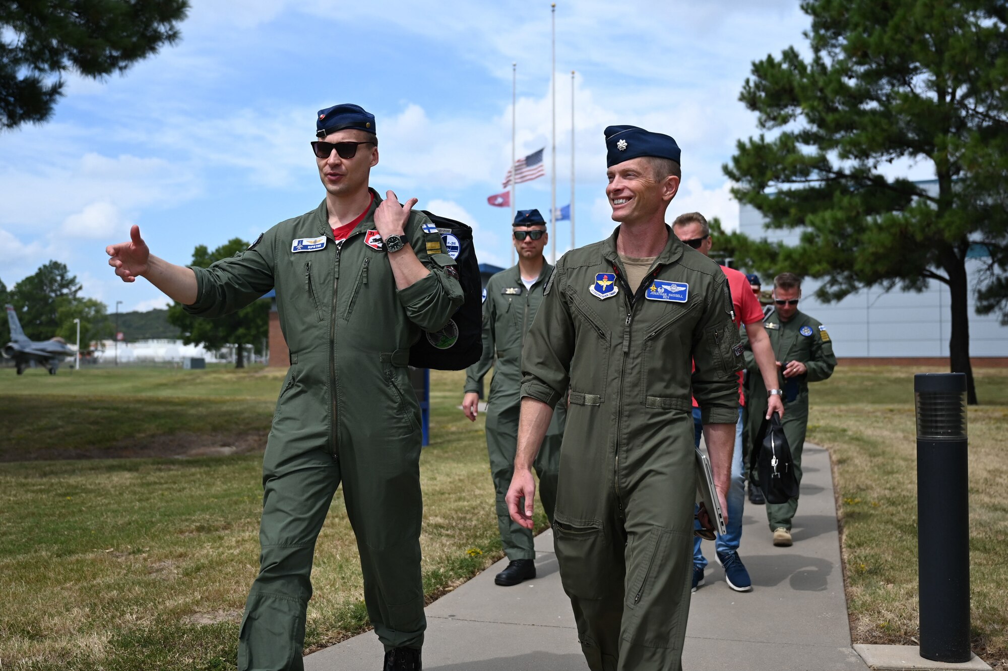 A Finnish pilot (left) walks alongside U.S. Air Force Lt. Col. Jonathan Hassell, 57th Fighter Squadron commander (right), during a tour of Foreign Military Sales support facilities at Ebbing Air National Guard Base, Arkansas, Sept. 11, 2024.