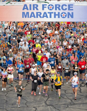 A high-angle photo of a large group of runners underneath a sign that reads "Air Force Marathon".