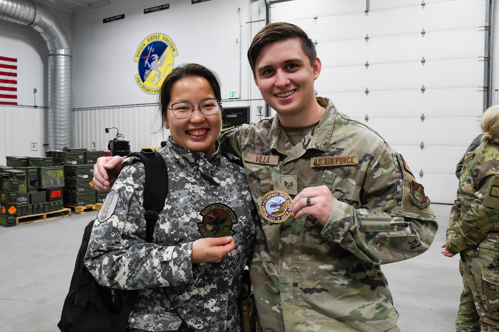 Staff Sgt. Joseph Villa, 168th Wing combat arms Instructor, trades patches with Lt. Enkh-Ariun, Mongolian National Emergency Management Agency Air Search and Rescue Unit Number 111, foreign cooperation senior specialist, after exchanging best practices, skills and stories about their weapons firing exercises Sept. 19, 2024. The Alaska National Guard and Mongolia are partners in the State Partnership Program.