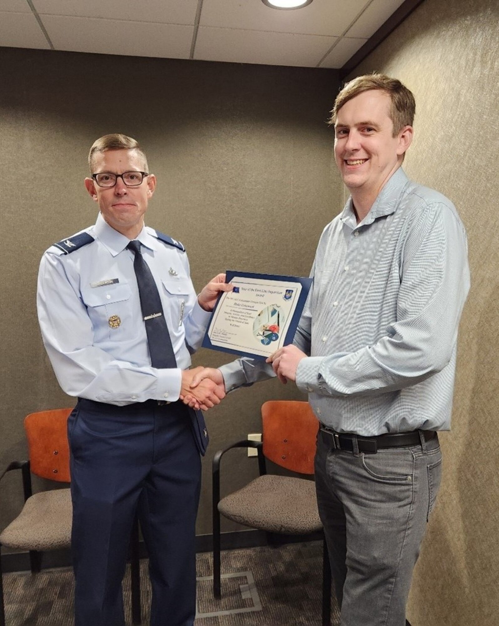 Two men holding certificate
