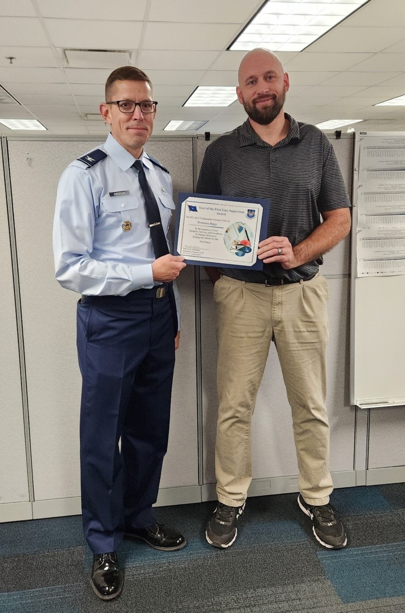 Two men holding certificate