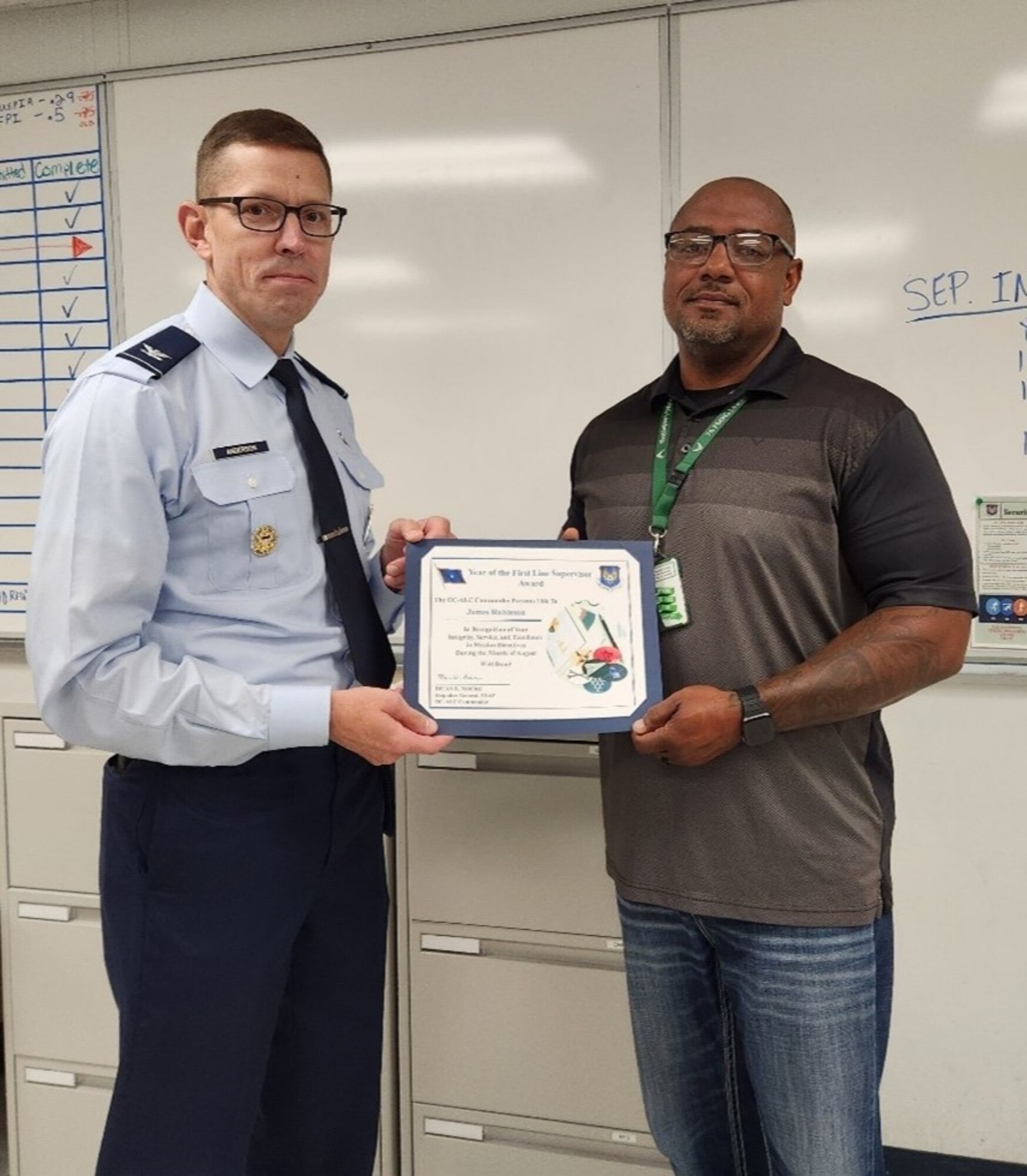 Two men holding a certificate