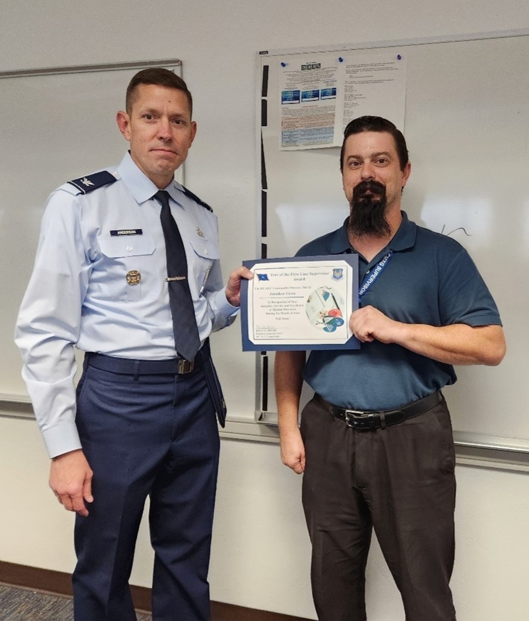 Two men holding a certificate