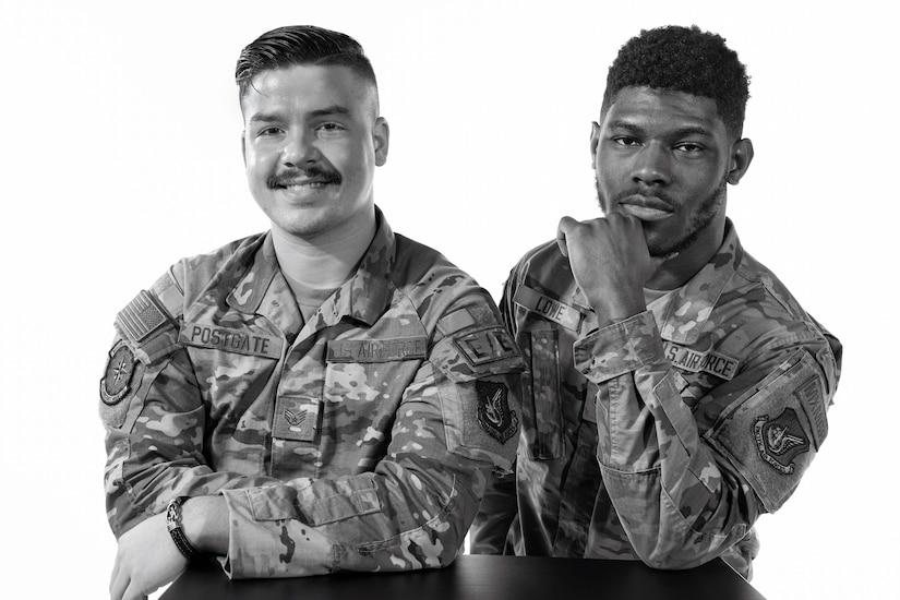 Two male uniformed service members pose for a portrait.