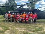 Soldiers with the 63rd Theater Aviation Brigade pose for a photo with members of the Wolfe County search and rescue team and Red Star Wilderness emergency medical services at the Disney Training Center in Artemus, Kentucky, Sept. 14, 2024. The Soldiers and the two rescue teams worked together in an all-hazards exercise to improve inoperability.