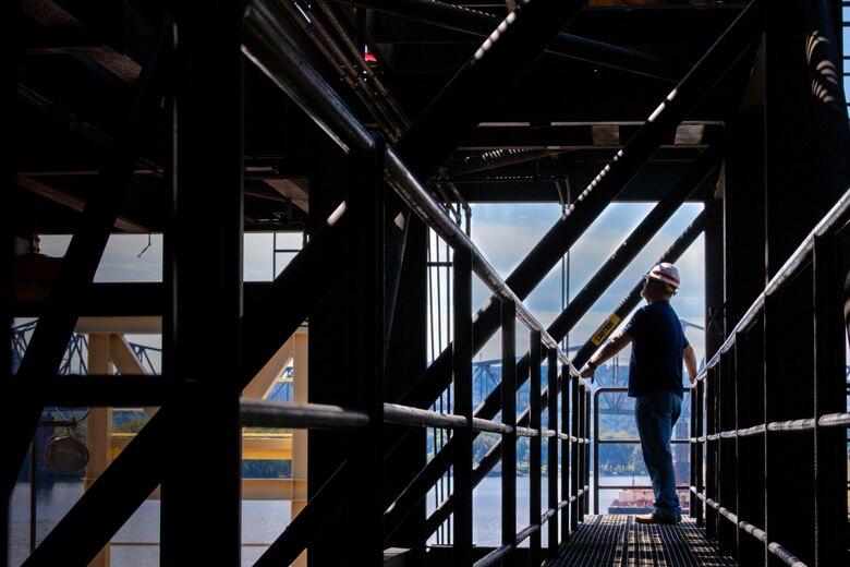 Brian Corrigan, the lockmaster at Hannibal Locks and Dam, observes repair work conducted on removed miter gates aboard the Henry M. Shreve floating heavy crane in Hannibal, Ohio, Sept. 13, 2024.